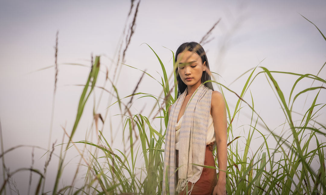 Saritha model walking in riceland Cambodia for natural cosmetics